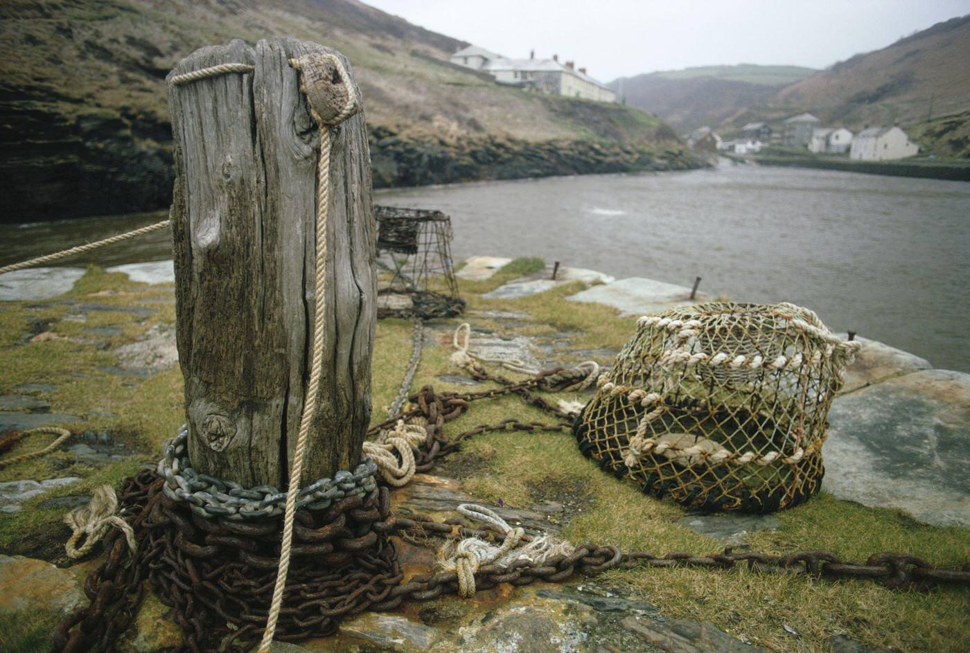 Mooring post with chains and fishing baskets, Boscastle port, Cornwall, April 1970.