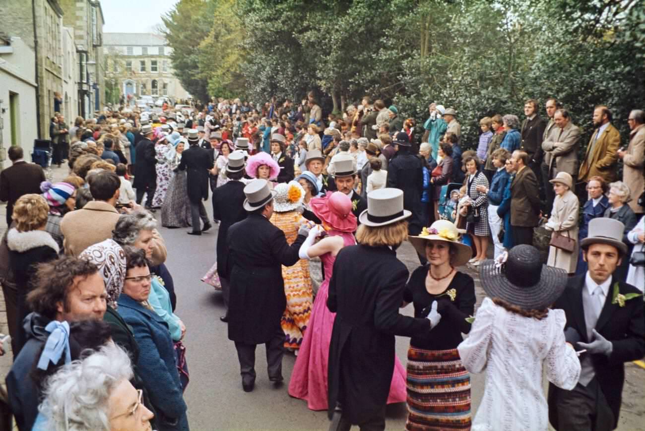 Crowds watch couples perform the Furry dance during Flora Day in Helston, Cornwall, 1973.