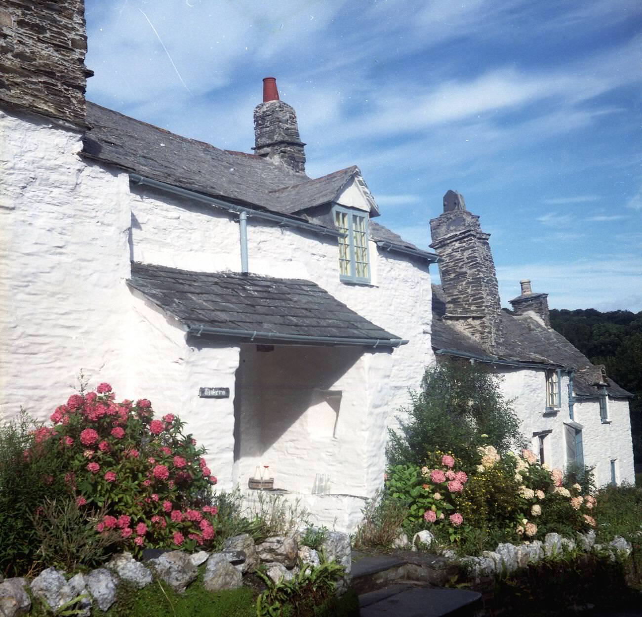 Pretty white-washed cottages in Boscastle, picturesque village with a natural harbor and access to the coast path, Cornwall, 1970s.