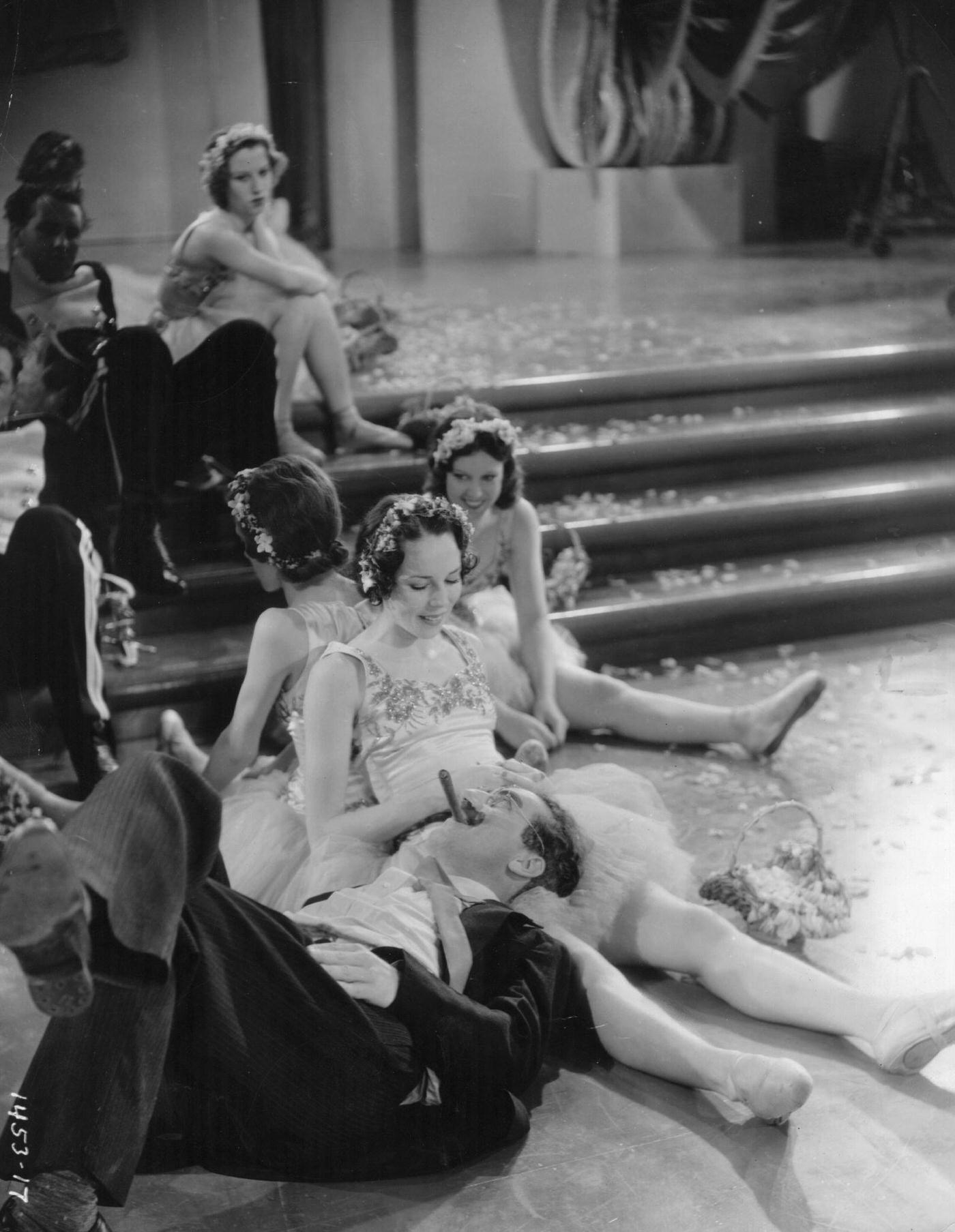 Groucho Marx finds himself surrounded by young beauties in a scene from Duck Soup (1933).
