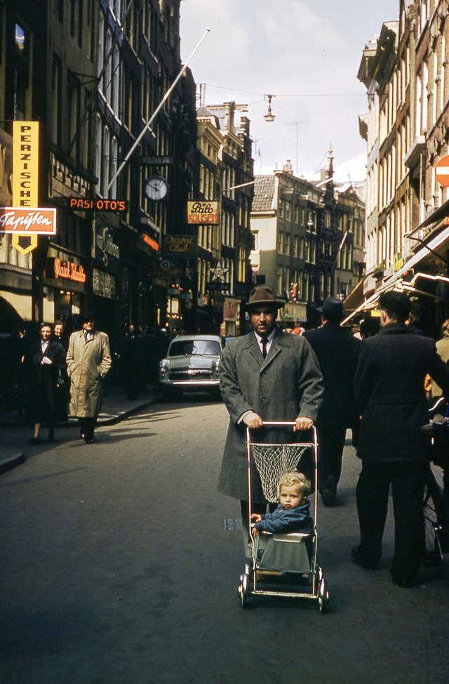 Man pushing the stroller on street in Trier, 1955