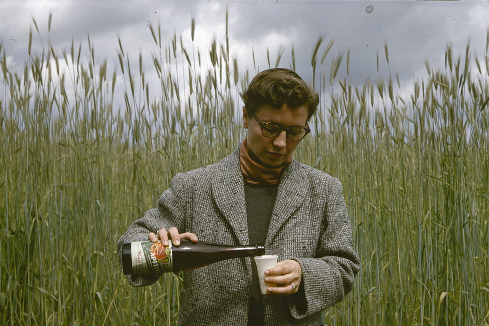 Pouring a glass of apple juice by a field somewhere in the Rhineland, 24 June 1958
