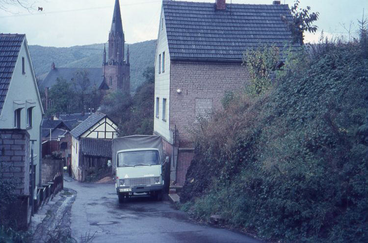 The Steinweg in Gemünd with a Hanomag. In the background- St. Nicholas Church in Gemünd (Schleiden), 1960s