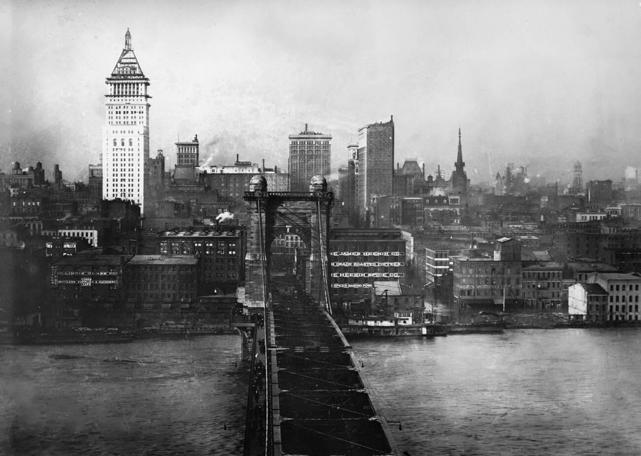 Cincinnati suspension bridge from the Kentucky side looking down on the flooded Ohio River and downtown Cincinnati, 1913.