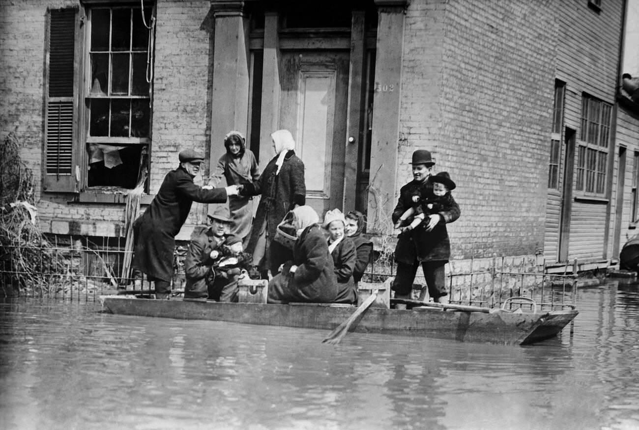 Workers rescuing a family in a rowboat after the flood in Dayton, Ohio, March 1913.