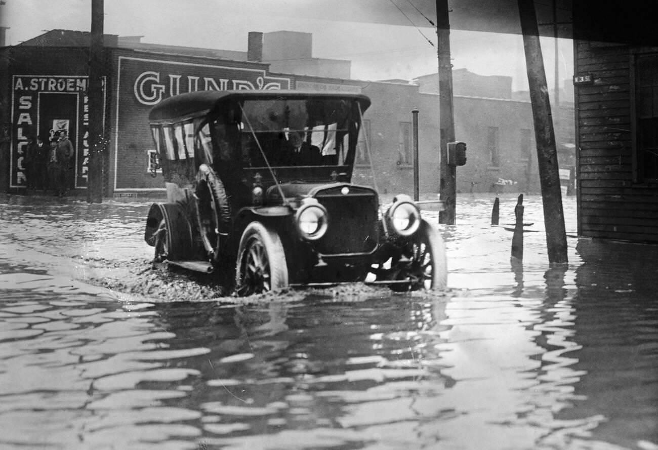 A car driving down a flooded street in Cleveland, Ohio, circa 1913.