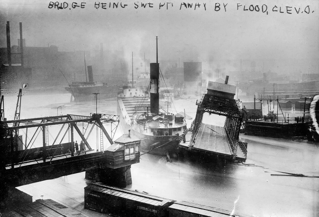 A bridge being swept away during a flood in Cleveland, Ohio, circa 1913.