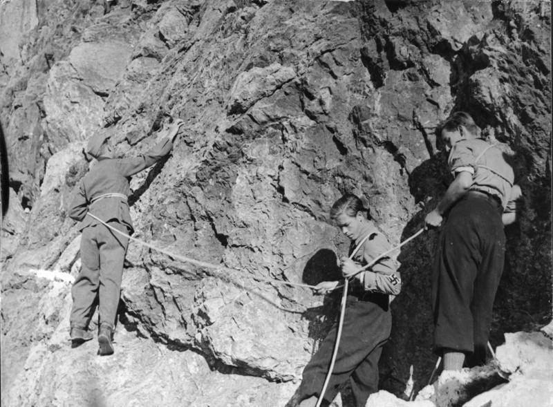 Hitler Youth members rock climing, Germany, 1930s.