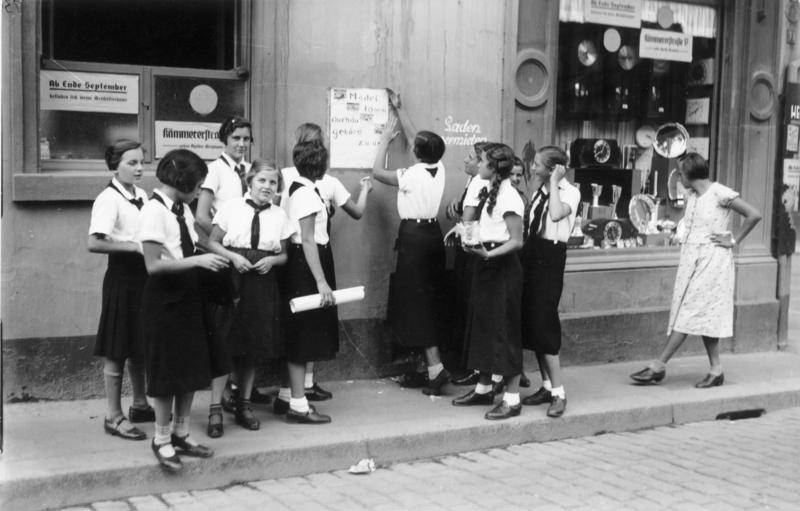 Members of the League of German Girls putting up recruiting posters, Worms, Germany, 1933-1945.