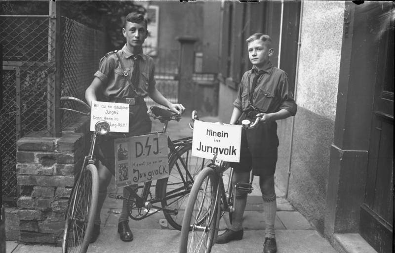 Members of the Hitler Youth with party slogan on display on their bicycles, Worms, Germany, 1930s.