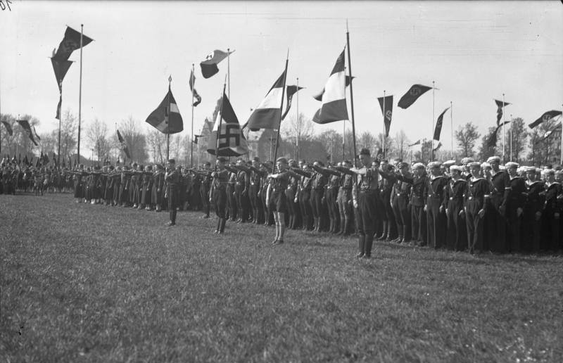Hitler Youth, Bund girls, and naval Hitler Youth children on a parade ground, Germany, 1 May 1937.