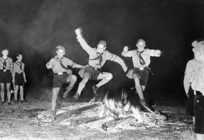 Hitler Youth members jumping over the solstice fire, Berlin, Germany, Jun 1937.