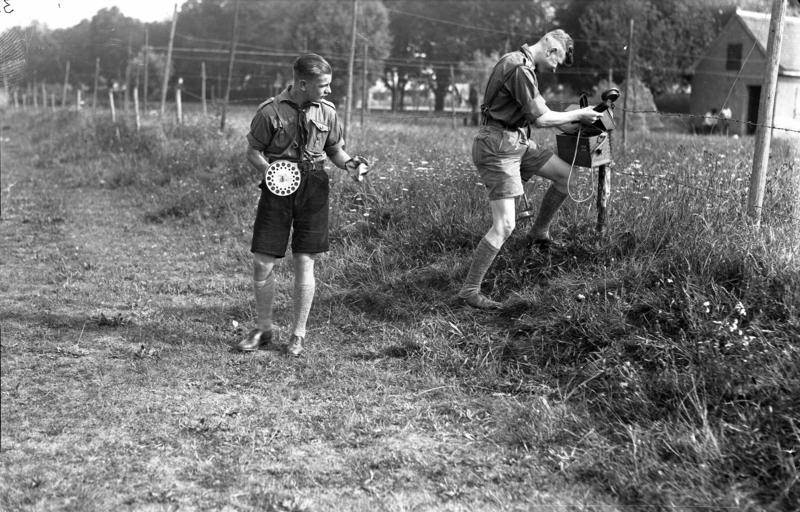 Members of the Hitler Youth laying field telephone wires in a military exercise, 1930s.