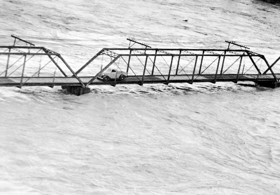 The James River crested at 27 feet in Richmond as one brave soul crossed the bridge to Belle Isle, 1937.