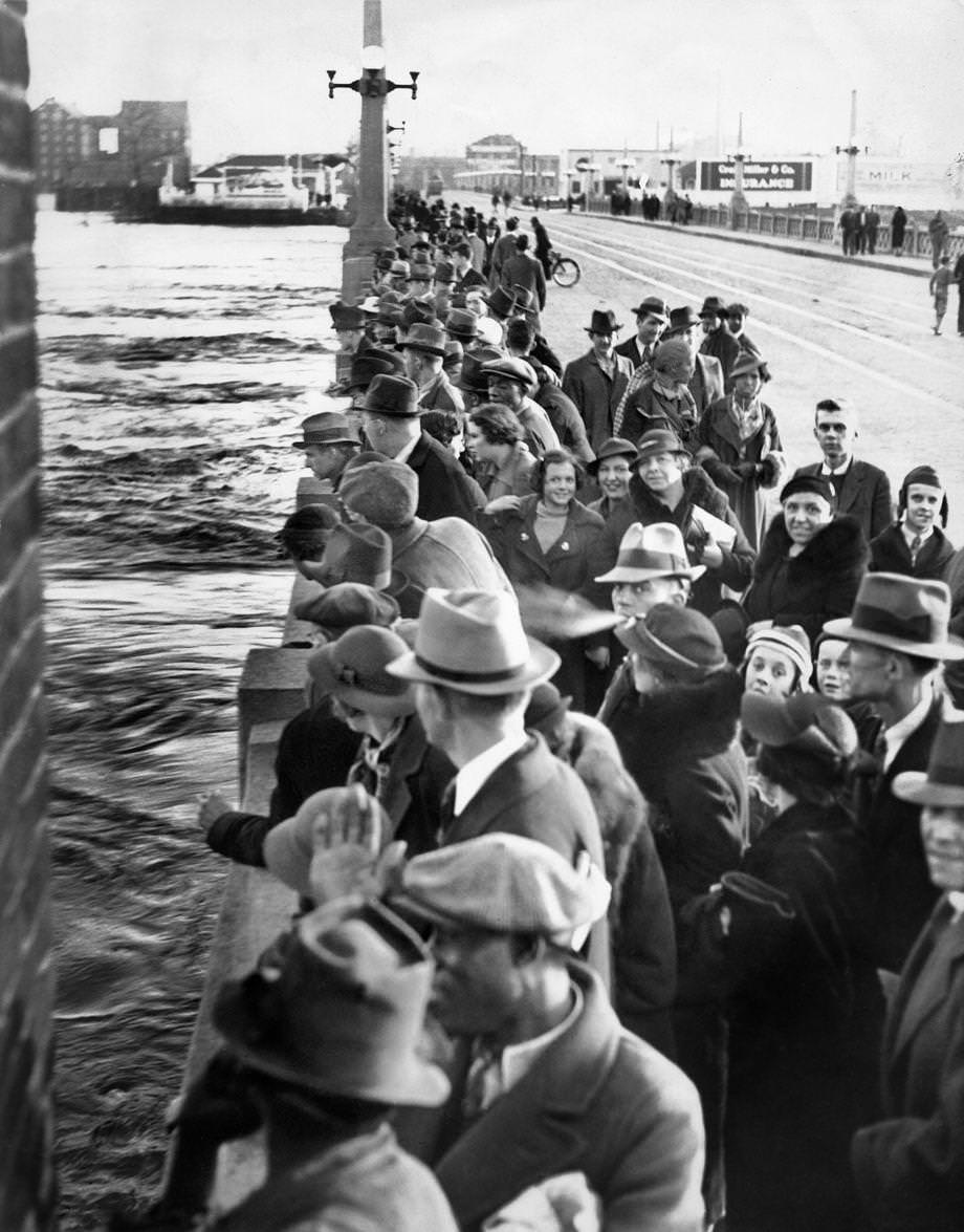 Throngs of Richmonders crowded the Mayo Bridge at 14th Street to view the torrent of the James River, 1936.