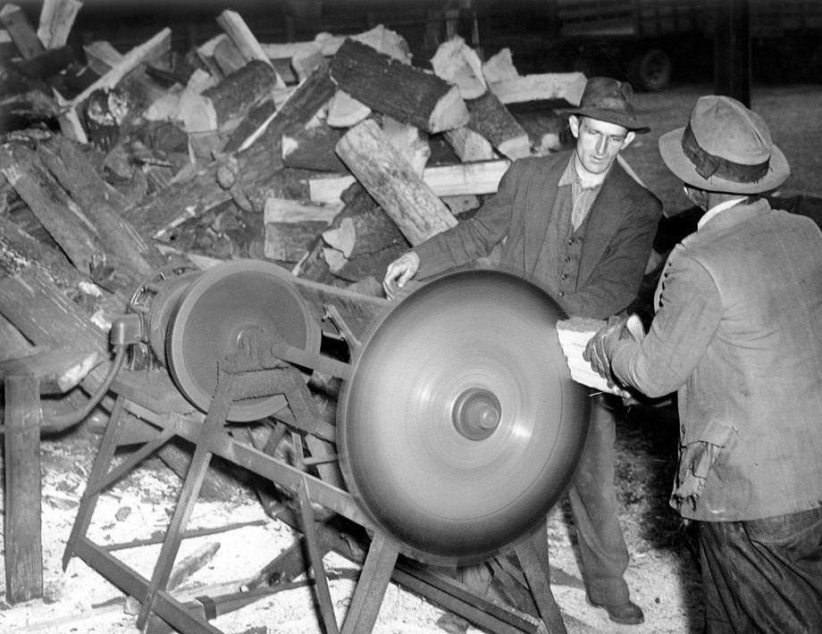 Citizens’ Service Exchange members Linwood F. Jones (left) and Daniel Evans engaged one of the numerous duties – cutting fuel for wood – for which members were paid in scrip instead of money, 1938.
