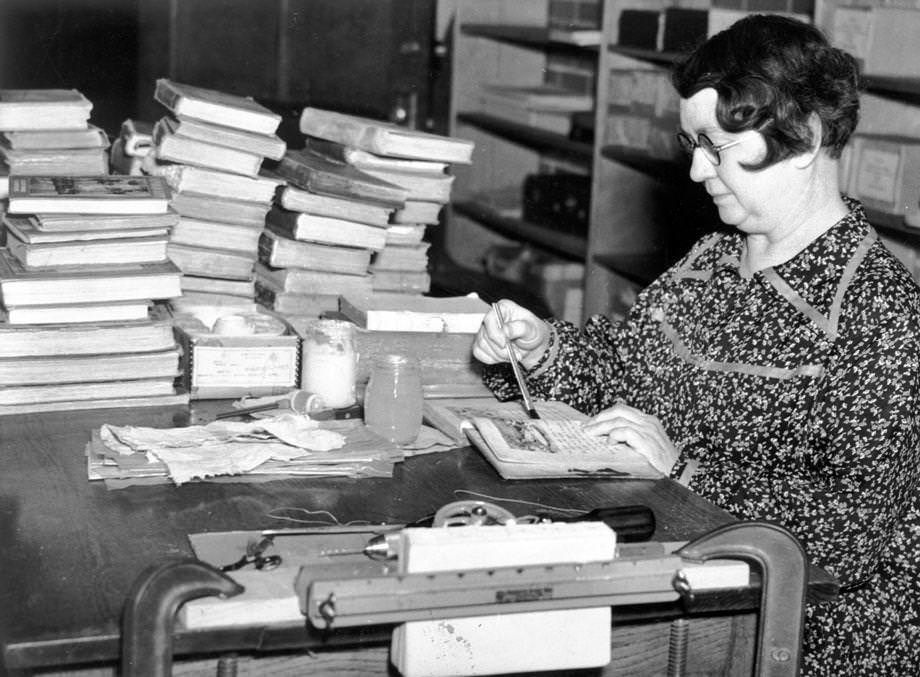 A woman working on a Works Project Administration bookbinding project in Suffolk in which hundreds of books were prepared for use in schools, 1938.