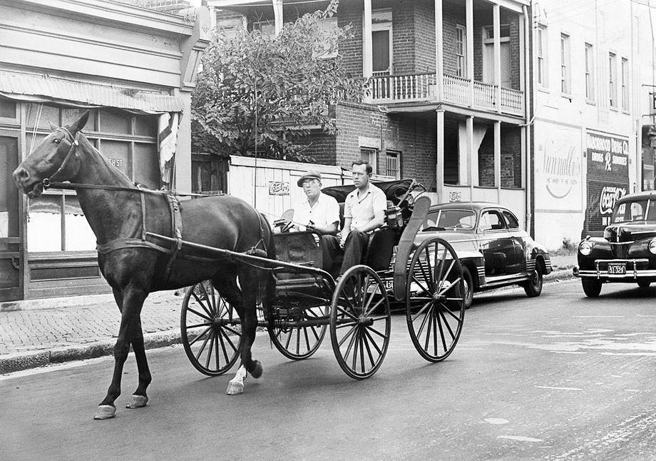 Amid a nationwide gas shortage, Harry J. Donati (left) and Joseph G. Robben drove their horse-drawn carriage down 25th Street in Church Hill in Richmond, 1941.