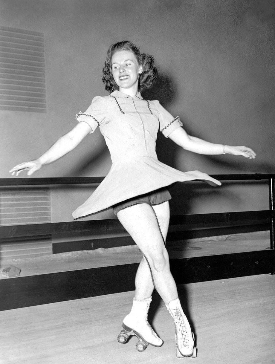 Billie MacIntire, a professional at the Cavalier Arena roller skating rink posed for a photo to promote her upcoming demonstration of a new routine, 1941.