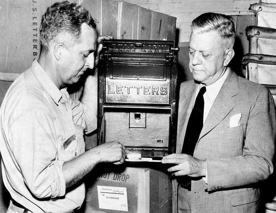 Carl A. Throckmorton (left) showed Richmond Postmaster Fergus McRee one of the 100 new mailboxes that would be installed at city street corners, 1949.