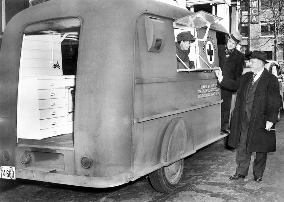 Mrs. J. Scott Parrish Jr., Gordon Sheain and Joe Brown examined a mobile kitchen that was part of the Red Cross Canteen Corps in Richmond, 1943.