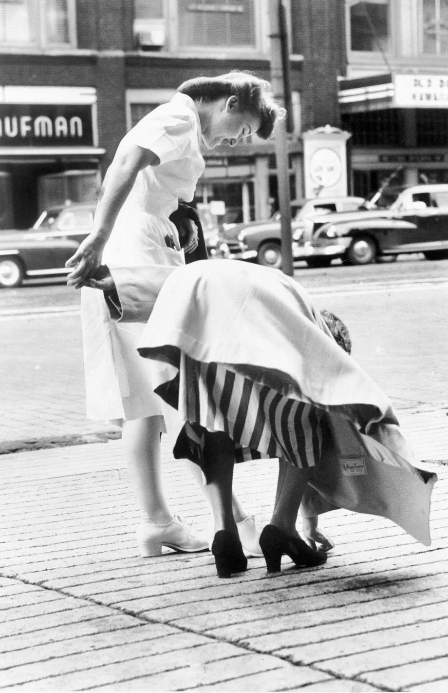 A woman tried to pick up a nickel from the sidewalk near Ninth and Broad streets in downtown Richmond – but it was a long-lasting prank, 1948.