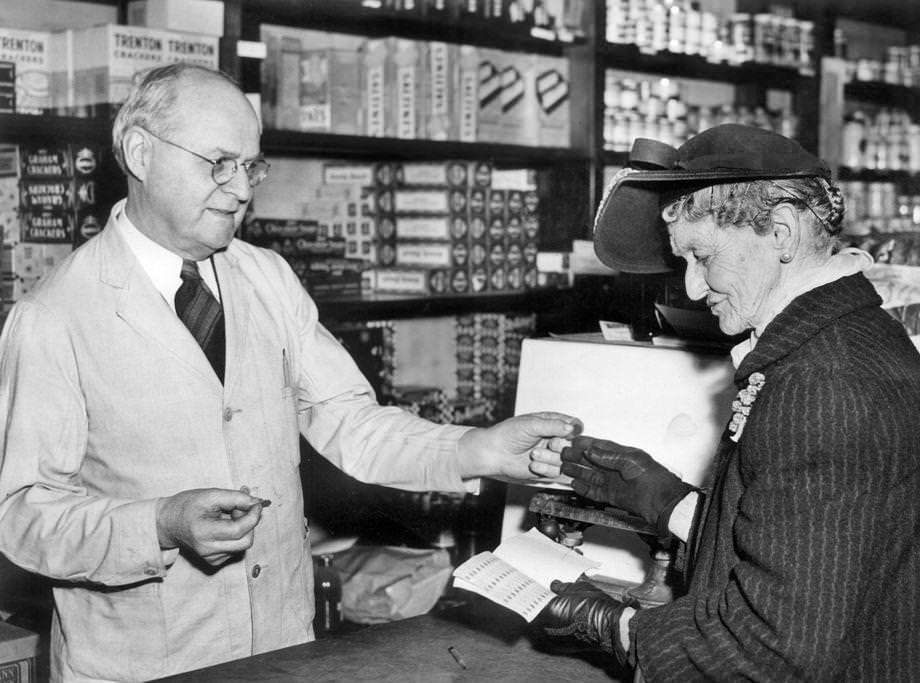 E.W. Saunders, a clerk at R.L. Christian & Co. in downtown Richmond, showed Mrs. L.E. Barber how to use ration tokens, 1944.