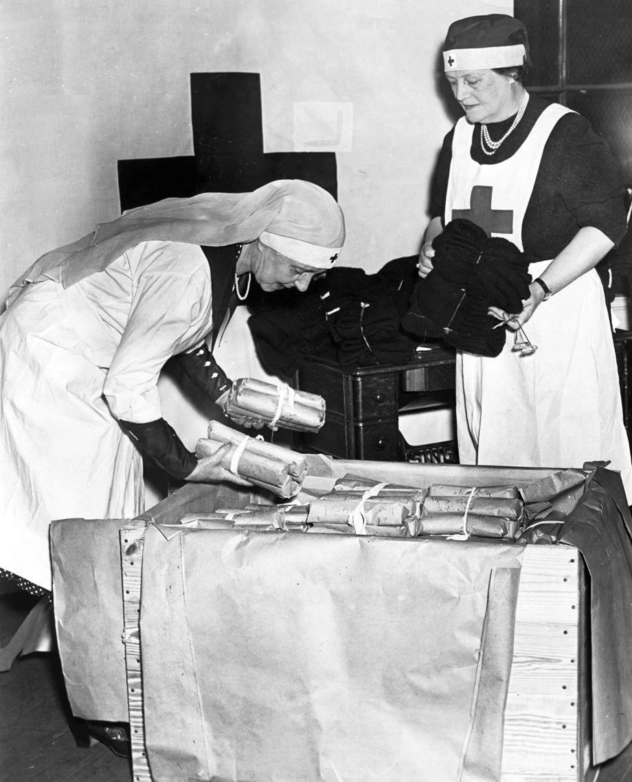 Mrs. St. George Bryan and Mrs. Lawrence Price helped pack more than 1,000 sweaters, socks, afghans and other items knitted by Richmond volunteers, which were being sent to the Red Cross "Mercy Ship" that sailed in June to deliver war relief to Europeans.