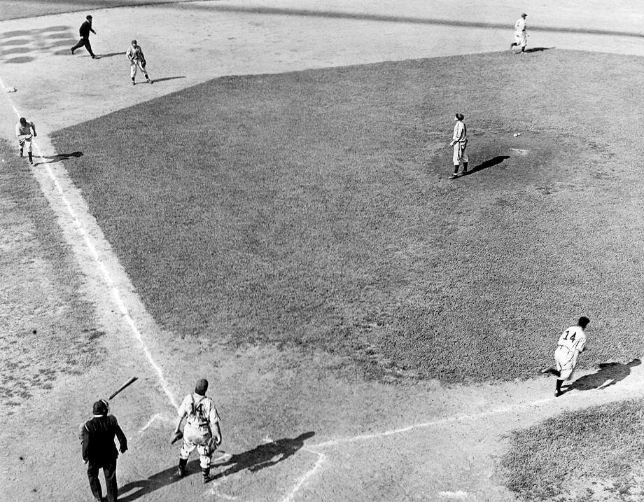 A Richmond Colts batter headed to first base while a teammate scored in a victory over the Norfolk Tars in a Piedmont League game at Tate Field, which was on Mayo Island in Richmond, 1940.