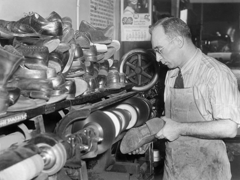 Aaron Hyman repaired a shoe in his Richmond store. With wartime shoe rationing, cobblers were swamped with business for repairs, 1943.