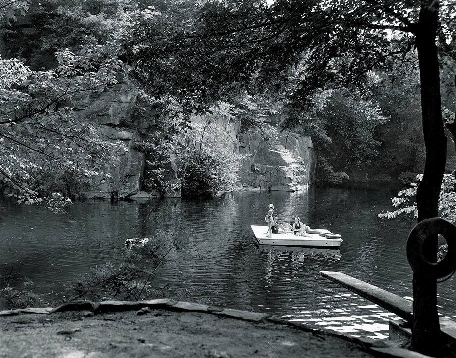 Women lounged on a floating platform at a swimming hole that was once a quarry, 1950.