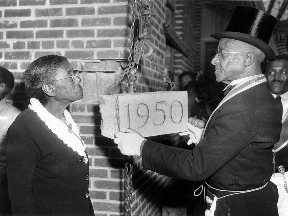 Virginia Randolph helped S.O. Spriggs, worshipful master of East End Lodge 233, A.F. & A.M., lay the cornerstone at a ceremony for a $262,000 addition to the former one-room schoolhouse in Glen Allen that Randolph started in 1892 and that was named for her.