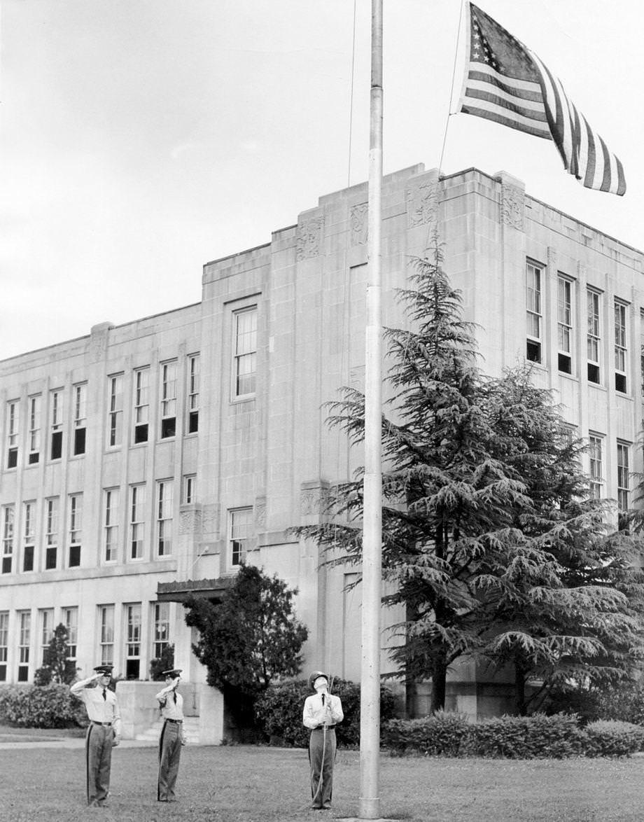 Three members of the Thomas Jefferson High School cadet corps completed their daily flag ritual, 1950.