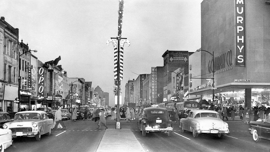 Pedestrians scurried across a busy Broad Street at Fourth Street in downtown Richmond as Christmas shopping was in full swing, 1955.