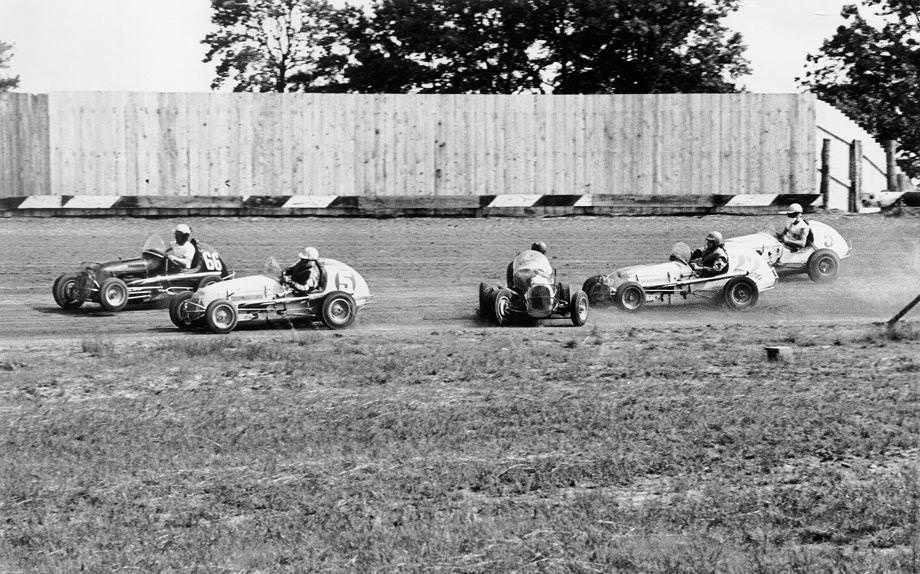 Bill Shockley of Greenville, S.C., spun out in an eight-lap midget auto heat on the half-mile dirt track at the State Fairgrounds, 1958.