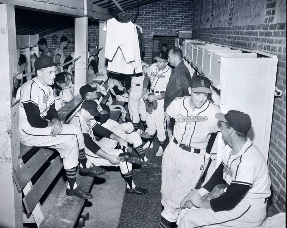 Members of the Richmond Virginians engaged in a pre-practice bull session in their locker room, 1955.