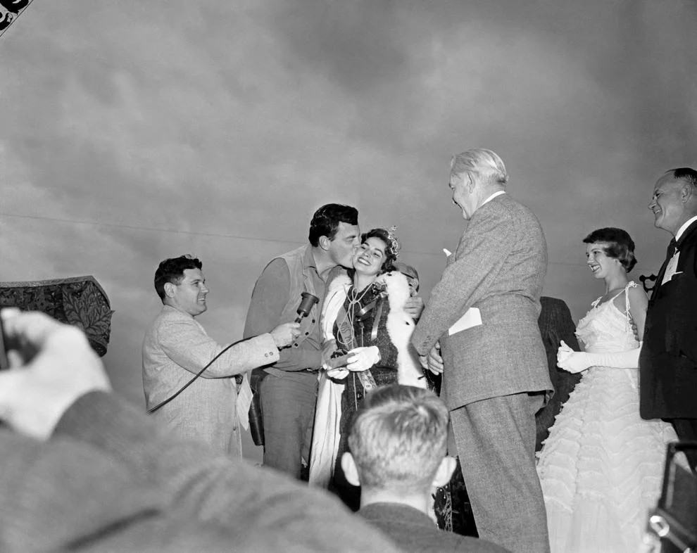 National Tobacco Festival parade grand marshal James Arness (Matt Dillon from TV's “Gunsmoke”) gave a kiss to that year's Tobacco Queen, Judy Ann Austin, 1958.