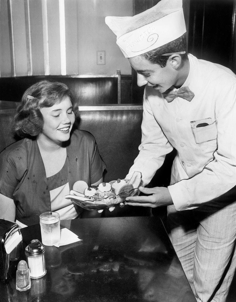 A curb boy at Arnette’s Ice Cream Co., served Beverly Page French a banana split, 1950. T