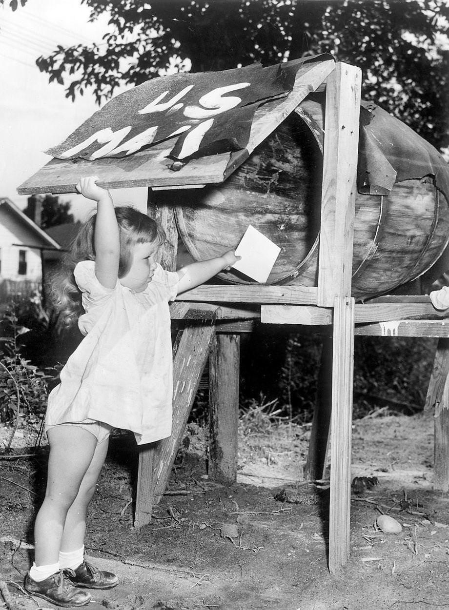 Sherry Gilman placed a letter in a barrel-turned-mailbox on Honaker Avenue in Richmond, 1950.