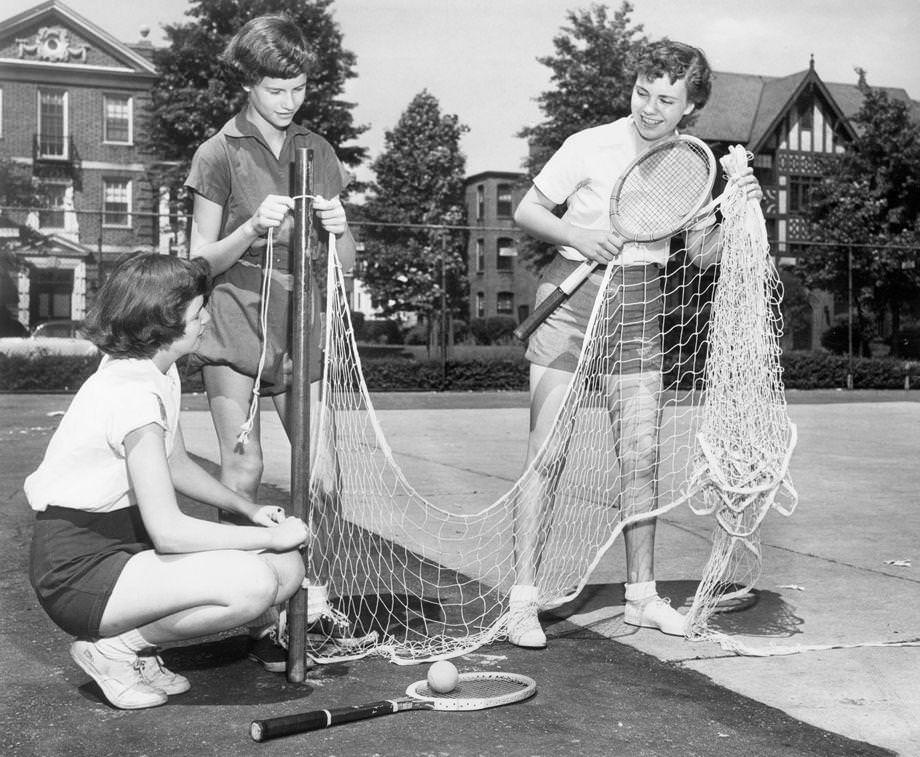 Barbara Kilday (from left), Becky Branch and Jill Arnold set up a net for tennis, 1950. The 14-year-olds were attending summer school in the Richmond area.