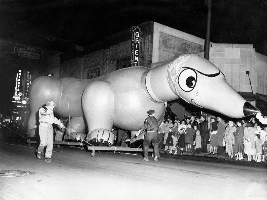 A dachshund float towered above spectators lining the curb during the Thalhimers Toy Parade in downtown Richmond, 1950.