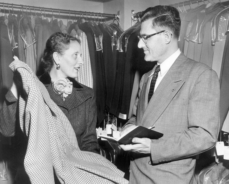Mrs. J.H. Boxley diverted her husband’s attention from his bookkeeping to show off new inventory at the L’Pell’s clothing store they owned on East Grace Street in Richmond, 1951.