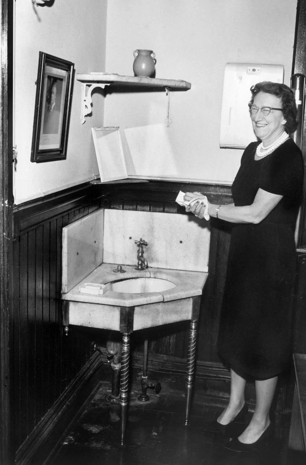 A woman used a sink located at Old City Hall on East Broad Street in Richmond, 1961.