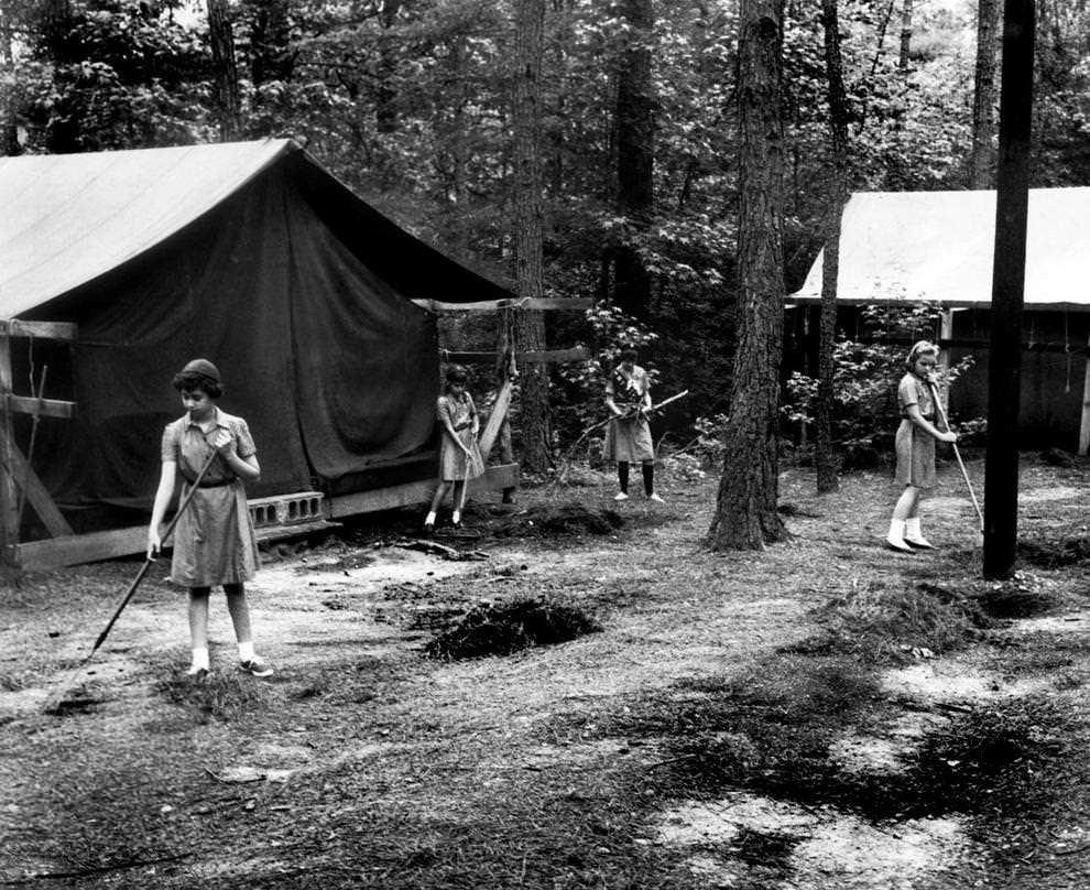 Girl Scouts cleaned the grounds at Camp Pocahontas near Bon Air in preparation for visitation and preview day, 1962.