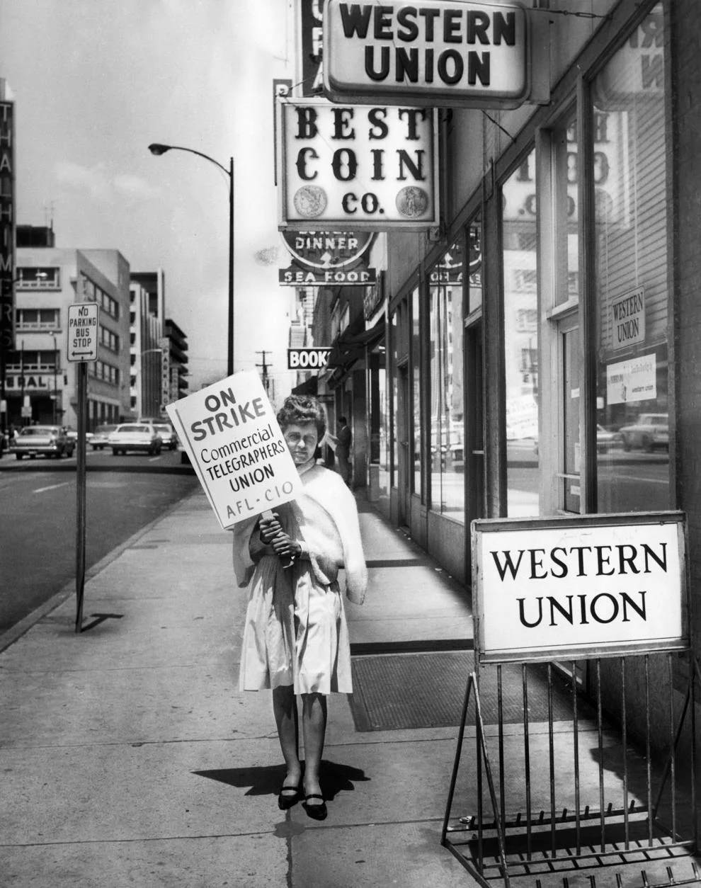 A woman picketed in front of a Western Union office in Richmond, 1966.