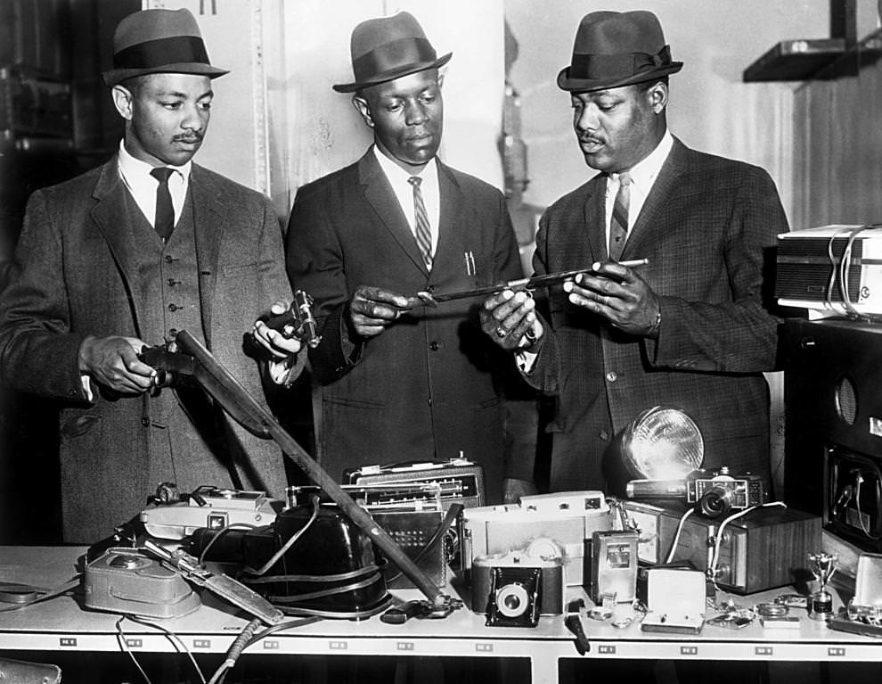 Richmond police officers (from left) Christopher Stokes, John W. Harris and H.L. Coleman reviewed items recovered from a series of North Side burglaries, 1966.