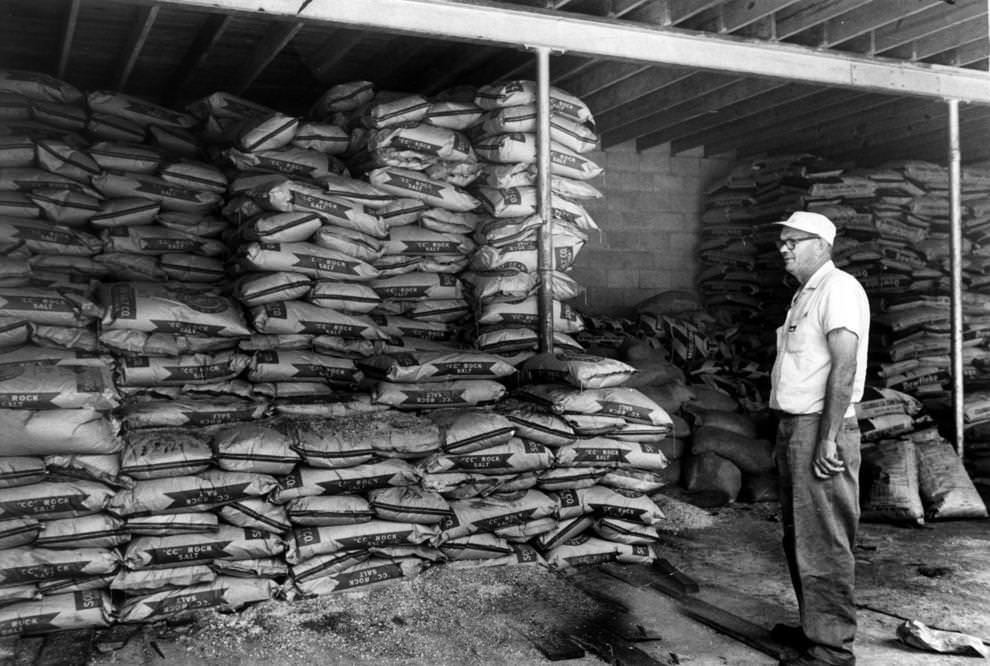 T.W. Redmond of the State Highway Department assessed the stock of anti-snow chemicals in a Richmond-area department storage shed on Midlothian Turnpike, 1961.