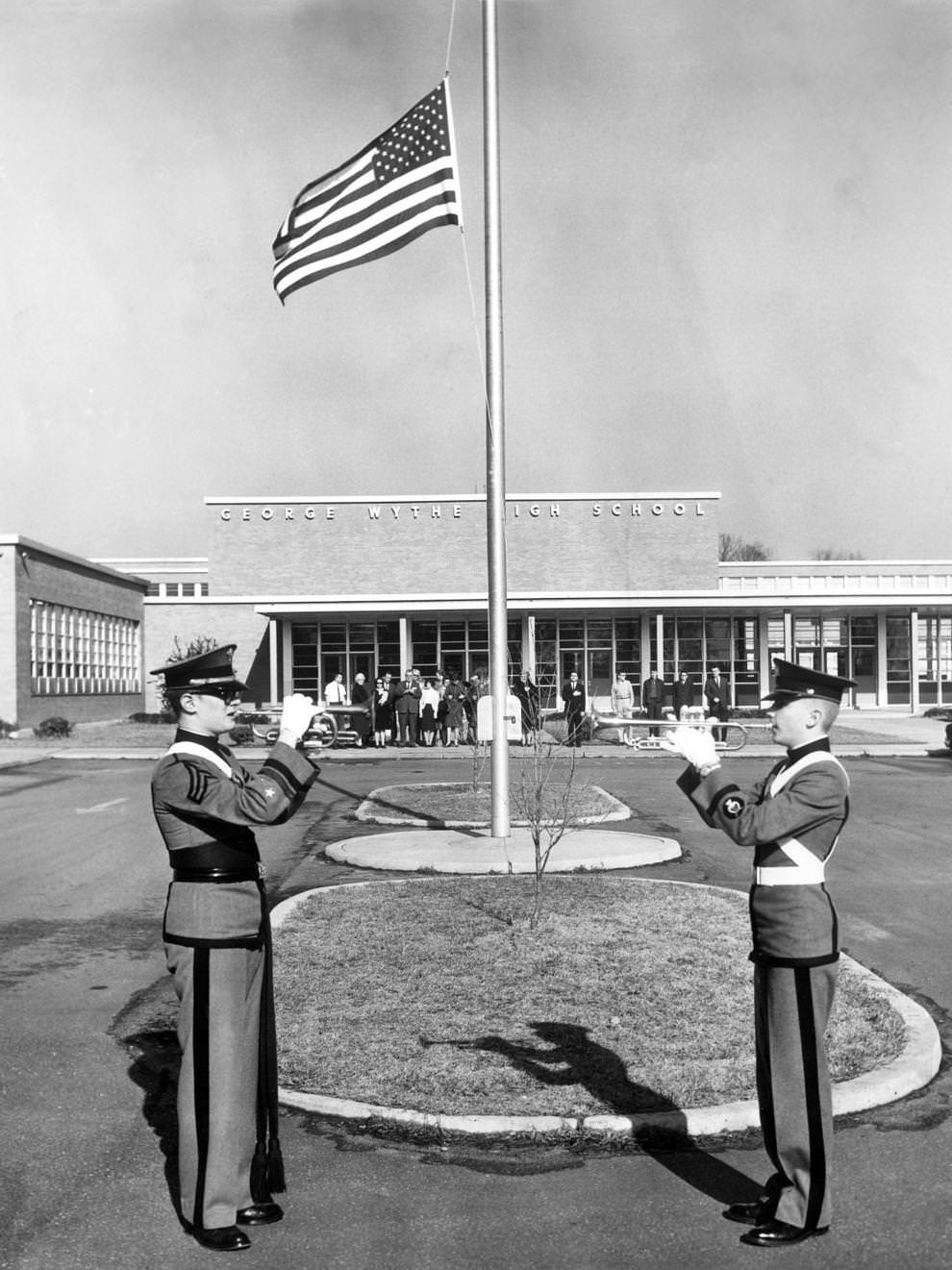 Victor Tomlinson (left) and William Hudson of the George Wythe High School cadet corps in Richmond blew taps while the school’s American flag flew at half-staff in honor of Winston Churchill, who died a day earlier. Gov. Albertis S. Harrison called for the weeklong recognition to mourn Britain’s World War II-era leader.