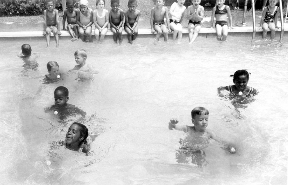 Children from the Follow Through program at the Ginter Park Presbyterian Church in Richmond demonstrated their swimming skills by directing ping pong balls across the pool, 1960.