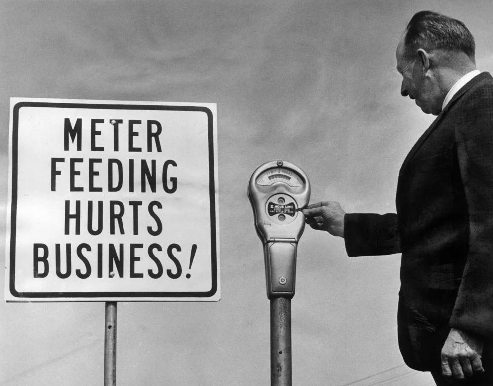 Richmond Safety Department supervisor B.W. Carver examined a parking meter downtown, 1966.